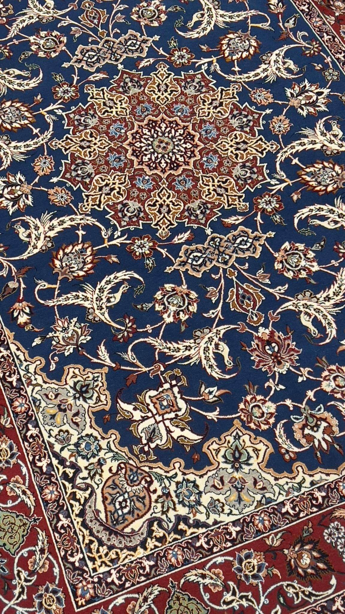 High-quality Seirafian carpet in bold blue and red tones for elegant decor.